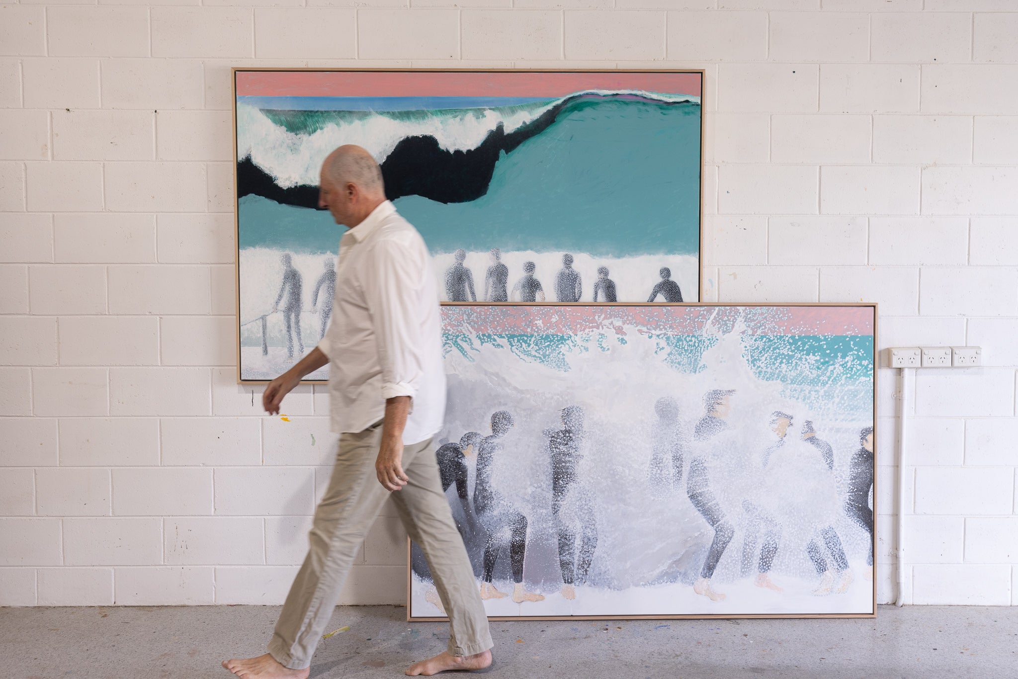 Mitchell English in his Noosa studio with two new paintings